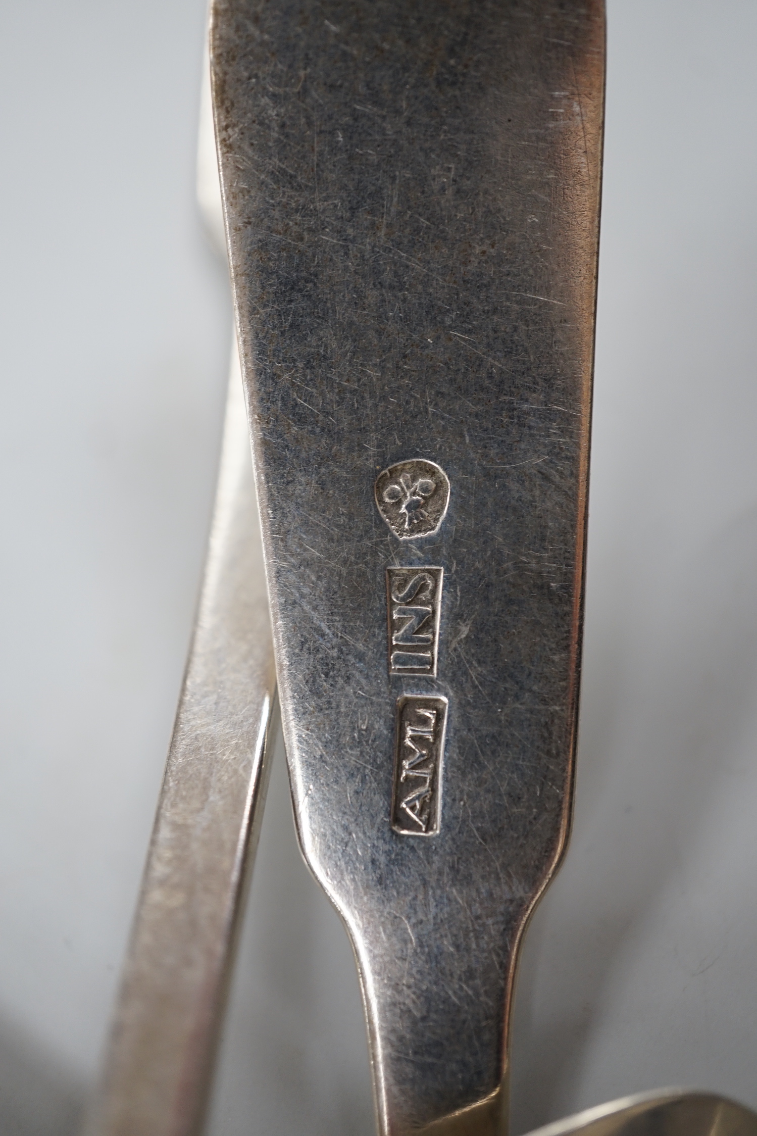 A set of nine early 19th century Scottish provincial silver fiddle pattern dessert spoons, 18.5cm and a pair of sauce ladles, by Alex MacLeod, Inverness, 11oz.